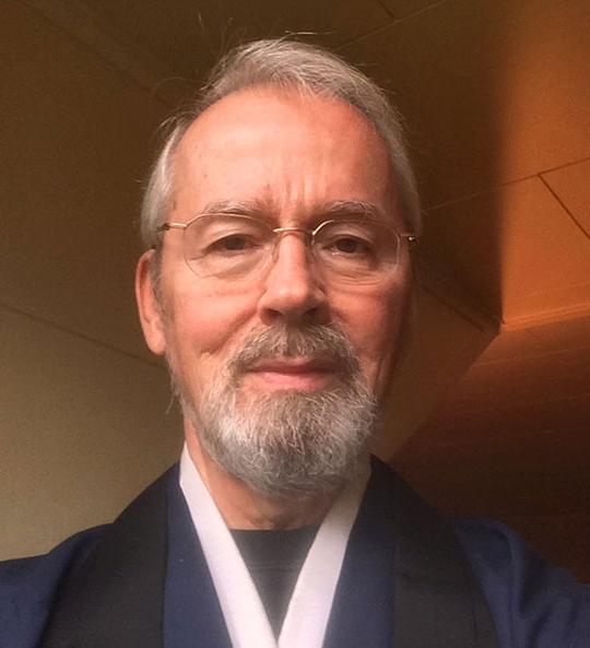 headshot of man with glasses and beard